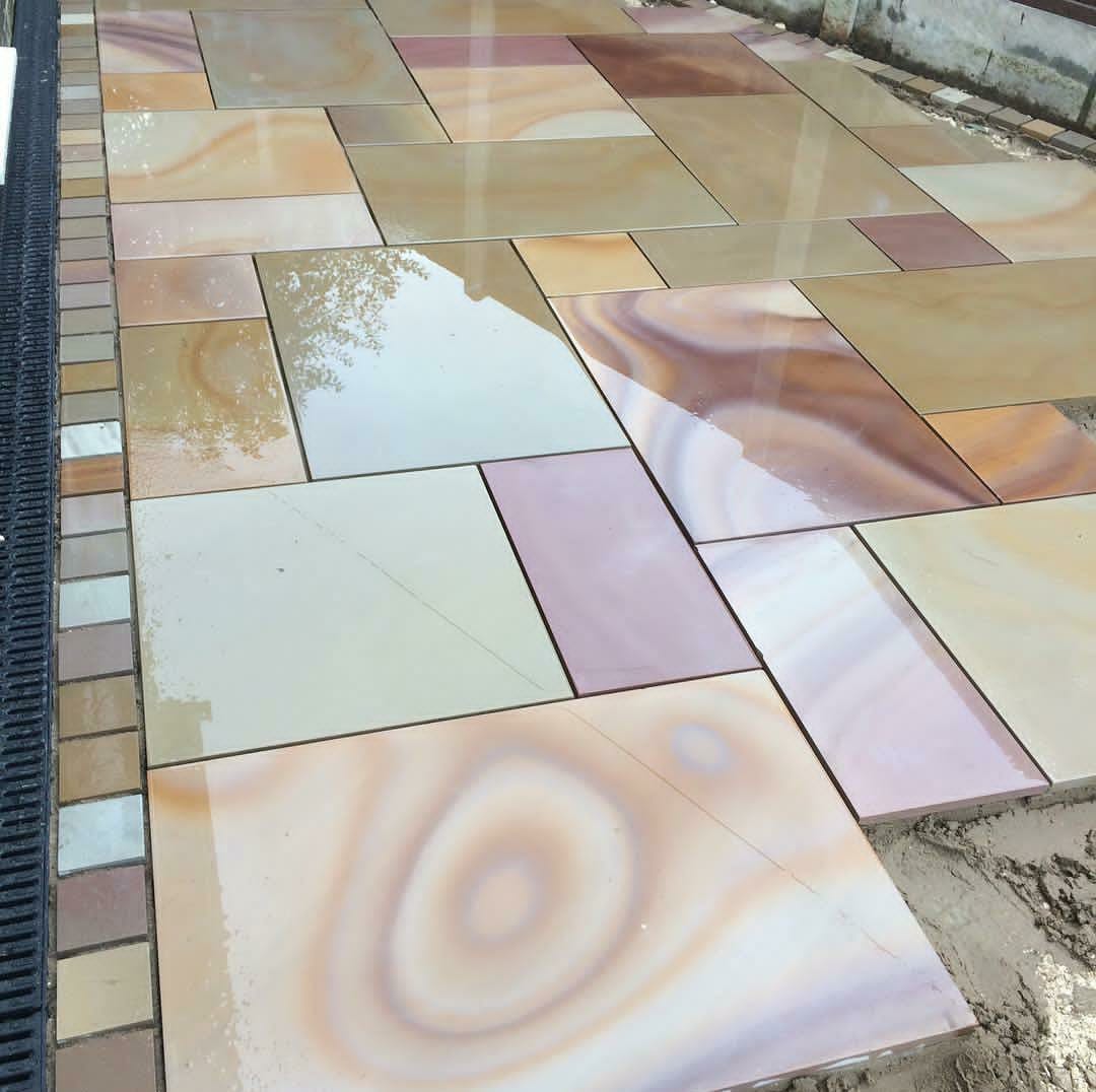 Honed face of Rippon Buff Smooth sandstone, warm buff with gold and pink banding