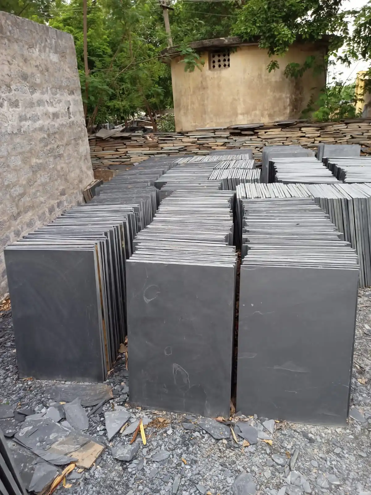 Stacked Brazilian Black slate slabs showing the cleft edge