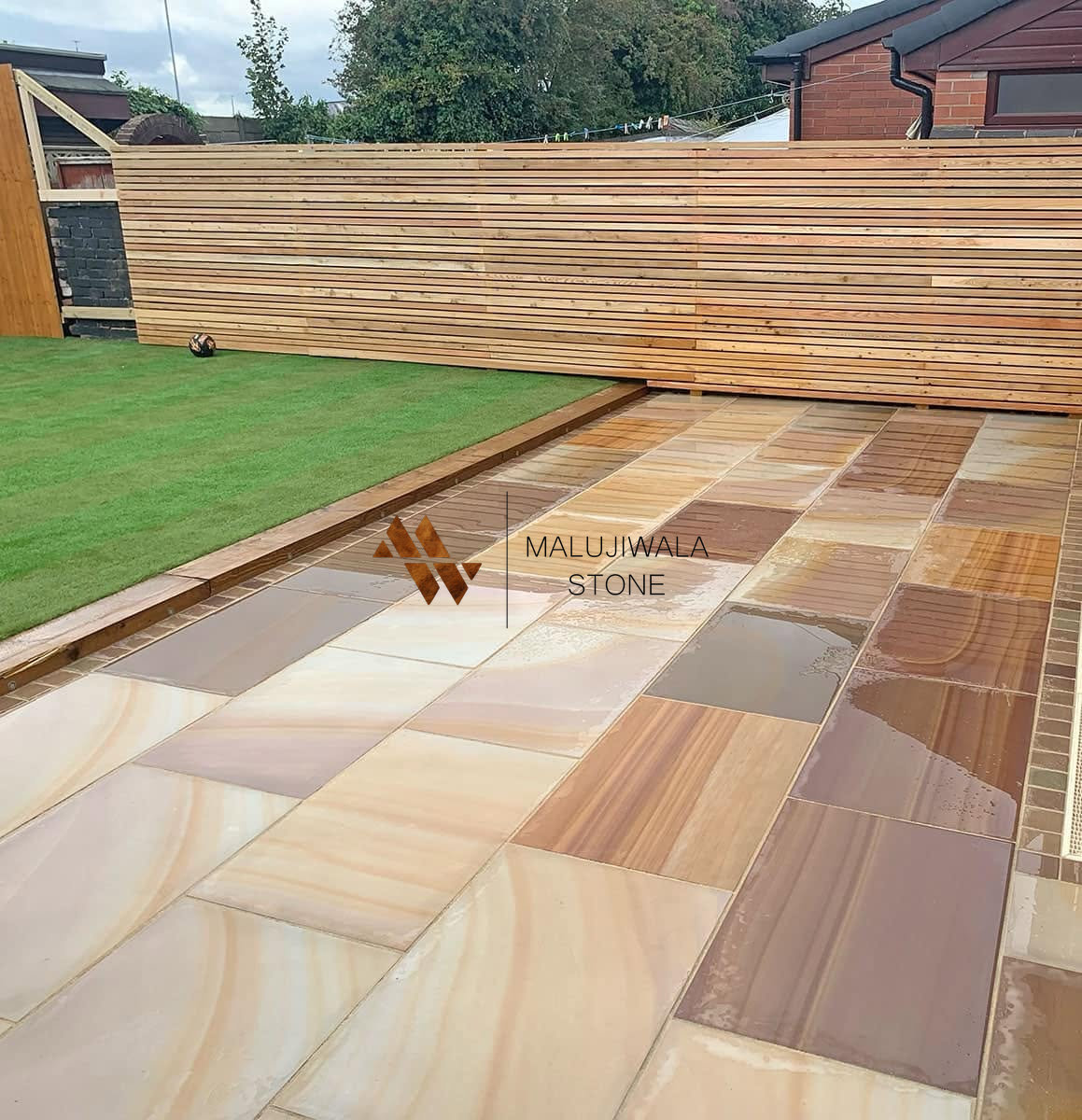 Smooth buff sandstone 600 x 900 paving laid across a patio