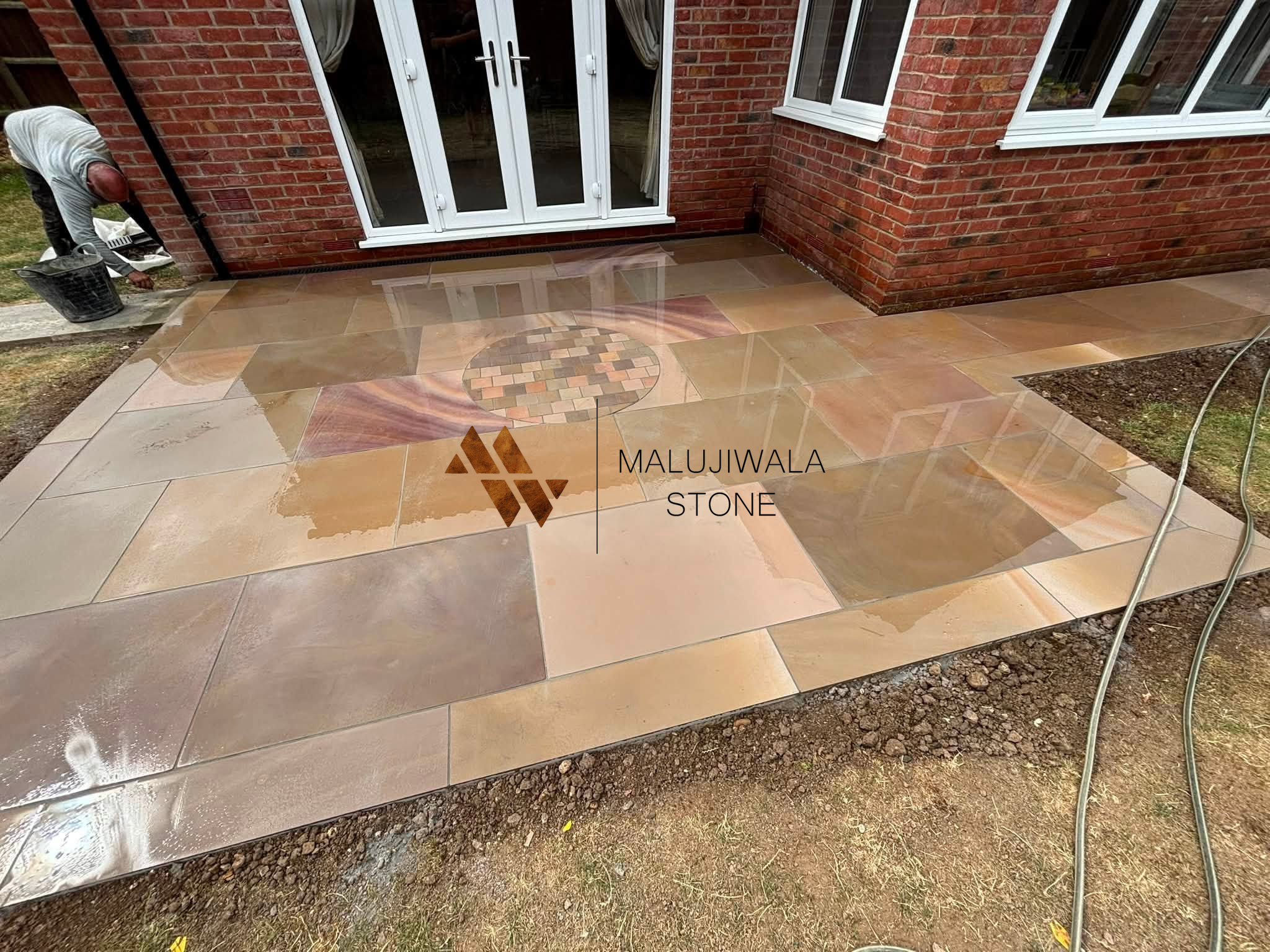 Smooth buff sandstone 600 x 900 paving seen at an angle in daylight