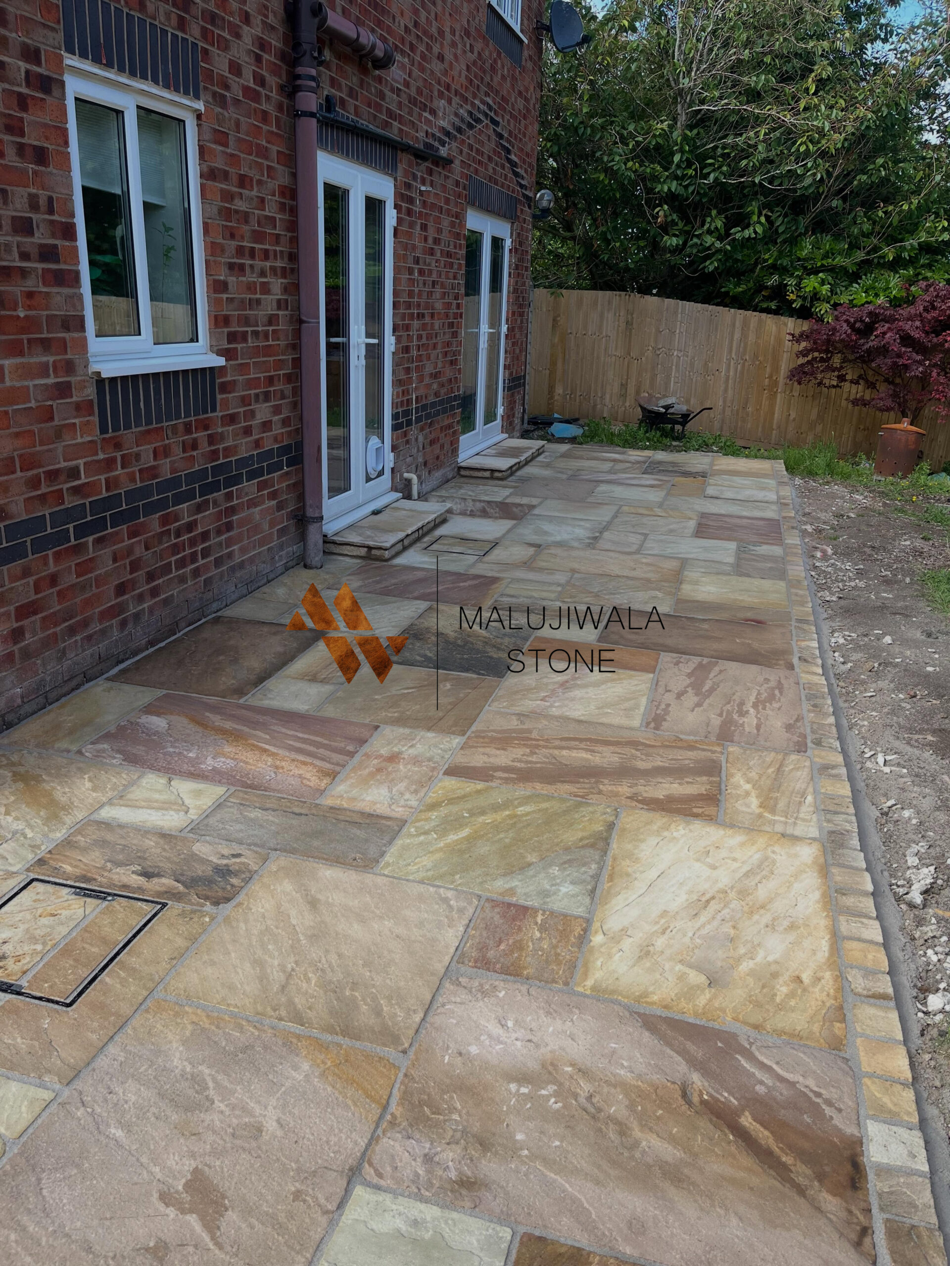 Riven mint sandstone patio laid in a mixed-size pattern