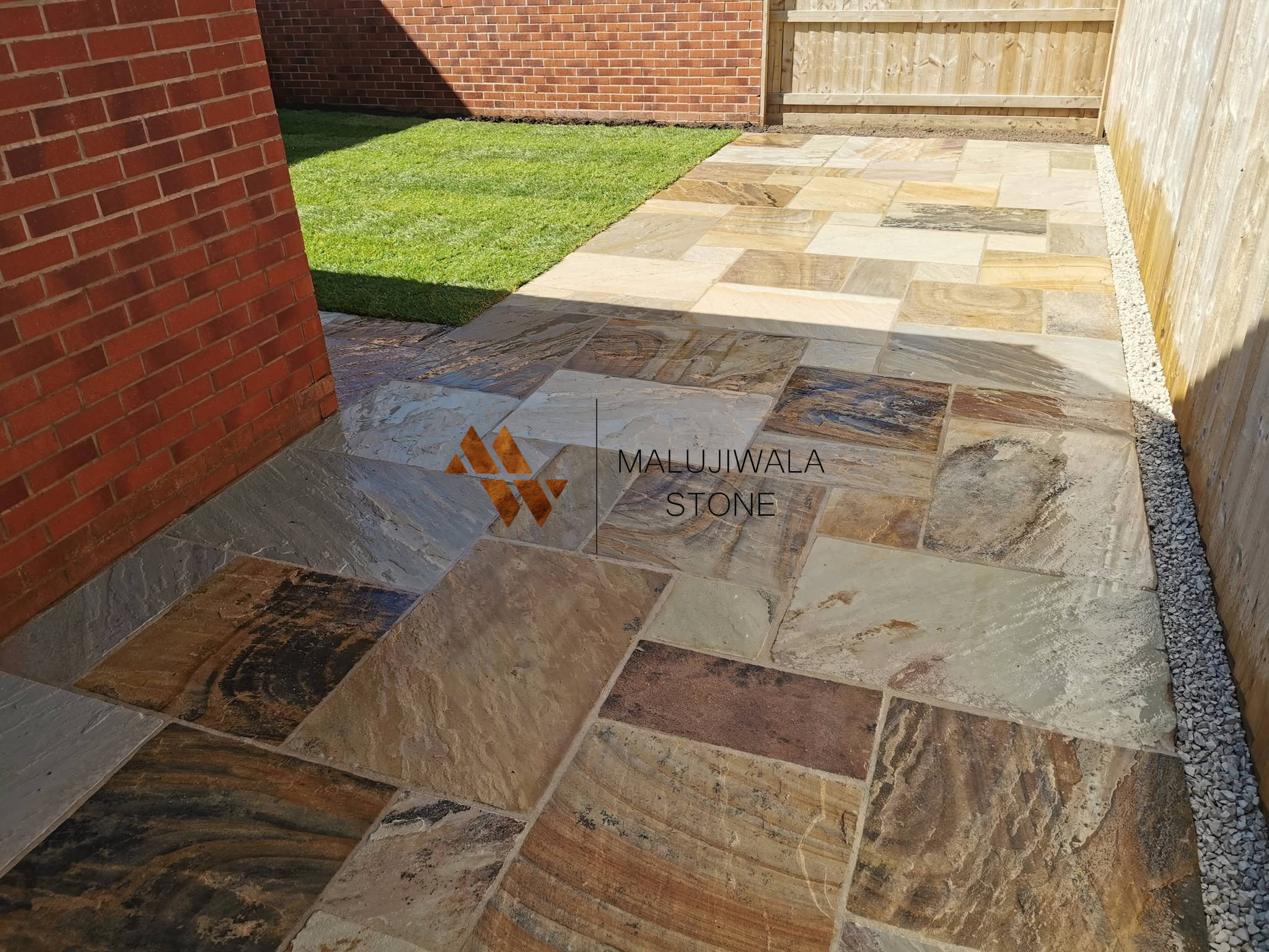 Fossil mint riven sandstone paving in a garden setting