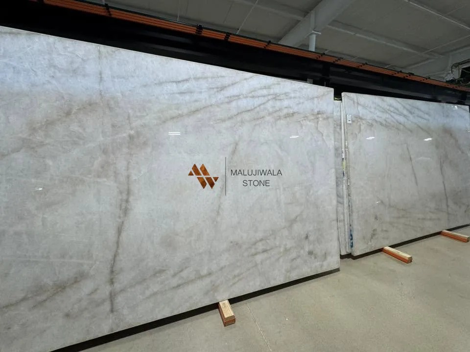 Two polished Cristallo quartzite slabs standing in a warehouse