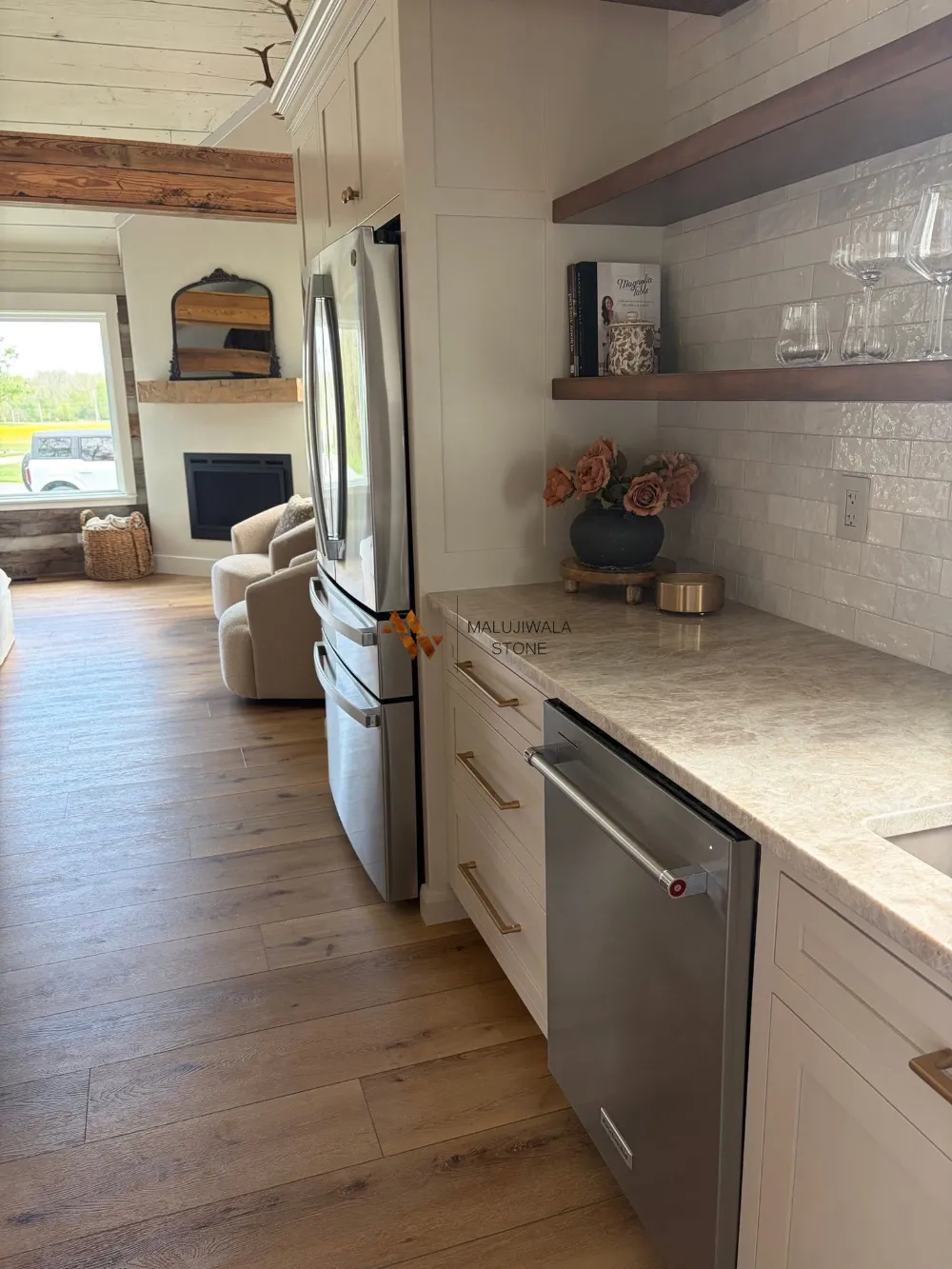 Taj Mahal quartzite perimeter countertop in an open-plan kitchen
